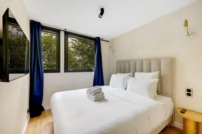 Un ou plusieurs lits dans un hébergement de l'établissement Appartement d'exception à Neuilly Achille Peretti I