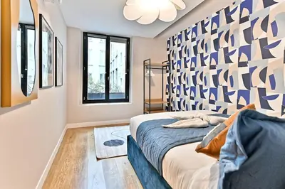 Un ou plusieurs lits dans un hébergement de l'établissement Appartement 3 chambres Paris 2ème - II