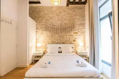 Un ou plusieurs lits dans un hébergement de l'établissement Cœur de Voltaire - Loft cosy Parisien