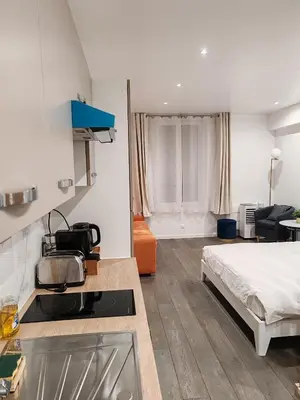 Un ou plusieurs lits dans un hébergement de l'établissement appartement champs elysees