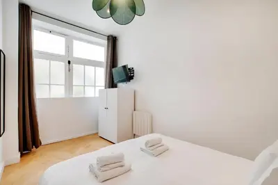 Un ou plusieurs lits dans un hébergement de l'établissement Appartement central-coeur de Paris