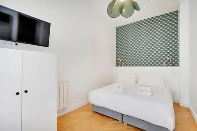 Un ou plusieurs lits dans un hébergement de l'établissement Appartement central-coeur de Paris