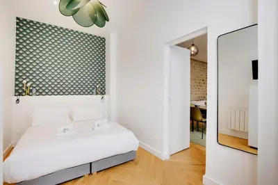 Un ou plusieurs lits dans un hébergement de l'établissement Appartement central-coeur de Paris