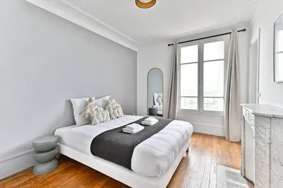 Un ou plusieurs lits dans un hébergement de l'établissement Appartement Vue panoramique sur la capitale - II