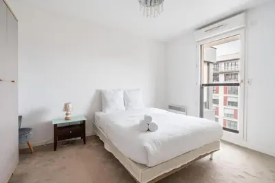 Un ou plusieurs lits dans un hébergement de l'établissement Appartement Fonctionnel Immeuble Neuf