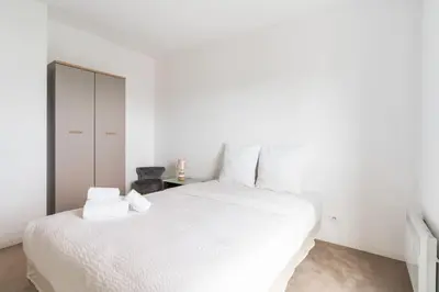 Un ou plusieurs lits dans un hébergement de l'établissement Appartement Fonctionnel Immeuble Neuf