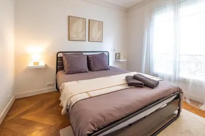 Un ou plusieurs lits dans un hébergement de l'établissement Spacious Apartment for 6 People