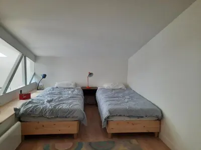 Un ou plusieurs lits dans un hébergement de l'établissement Loft 4-5 personnes à Montmartre - parking privé sur réservation