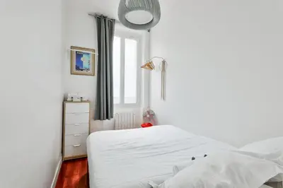 Un ou plusieurs lits dans un hébergement de l'établissement GuestReady - Apt. Vintage au centre de Paris