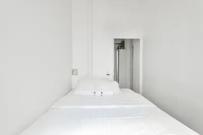 Un ou plusieurs lits dans un hébergement de l'établissement GuestReady - Apt. Vintage au centre de Paris