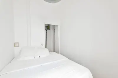 Un ou plusieurs lits dans un hébergement de l'établissement GuestReady - Apt. Vintage au centre de Paris