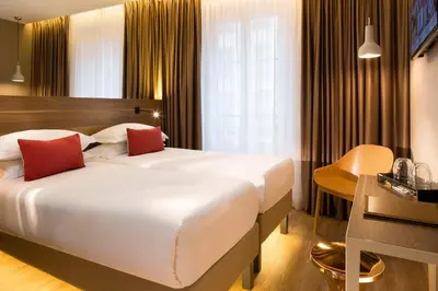 Un ou plusieurs lits dans un hébergement de l'établissement Cler Hotel