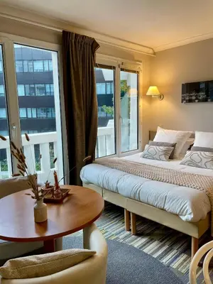 Un ou plusieurs lits dans un hébergement de l'établissement Paris Porte de Versailles Cosy Lodge 2 Appart hôtel parking wifi 4 pers