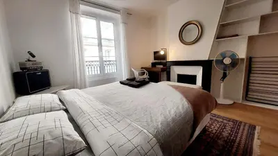 Un ou plusieurs lits dans un hébergement de l'établissement Beau et charmant appartement à Bastille