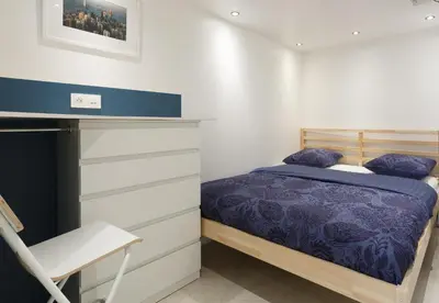 Un ou plusieurs lits dans un hébergement de l'établissement Appartement Petits Champs