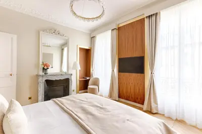 Un ou plusieurs lits dans un hébergement de l'établissement Artistic Luxury 3-Bedroom Apartment - Champs-Élysées