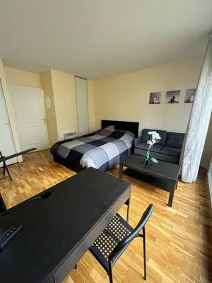 Un ou plusieurs lits dans un hébergement de l'établissement Studio neuf proche de Paris