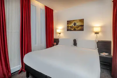 Un ou plusieurs lits dans un hébergement de l'établissement Hotel du College de France