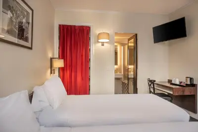 Un ou plusieurs lits dans un hébergement de l'établissement Hotel du College de France