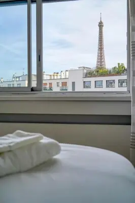 Un ou plusieurs lits dans un hébergement de l'établissement Cozy apartment 5 people Tour Eiffel - Champ de Mars
