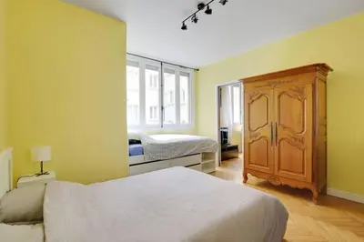 Un ou plusieurs lits dans un hébergement de l'établissement Bright Getaway near Montparnasse