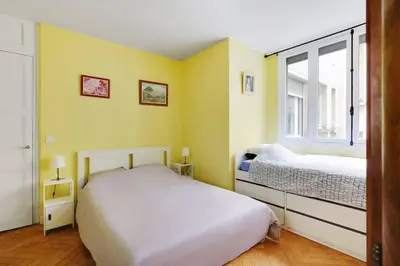 Un ou plusieurs lits dans un hébergement de l'établissement Bright Getaway near Montparnasse