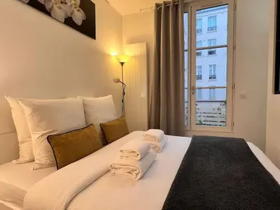 Un ou plusieurs lits dans un hébergement de l'établissement Grand Studio 2 pers République Bastille Paris 3