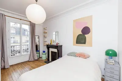 Un ou plusieurs lits dans un hébergement de l'établissement Charmant appartement avec vue