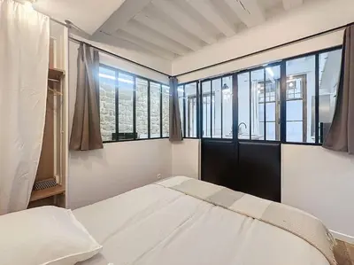 Un ou plusieurs lits dans un hébergement de l'établissement Loft en plein coeur du Marais