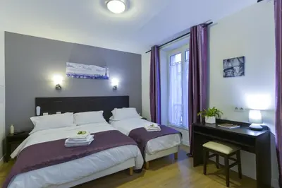 Un ou plusieurs lits dans un hébergement de l'établissement Hôtel du Quai de Seine