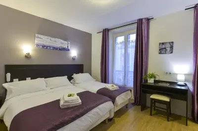 Un ou plusieurs lits dans un hébergement de l'établissement Hôtel du Quai de Seine