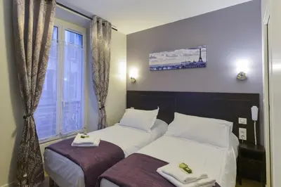 Un ou plusieurs lits dans un hébergement de l'établissement Hôtel du Quai de Seine