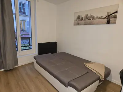 Un ou plusieurs lits dans un hébergement de l'établissement Appartement centre de Paris 19