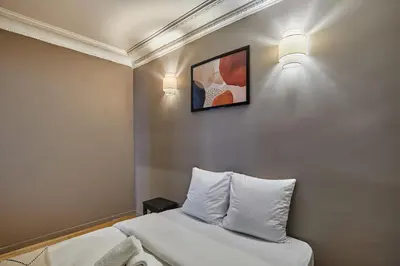 Un ou plusieurs lits dans un hébergement de l'établissement Charming Apartment Center of Paris by Studio Prestige