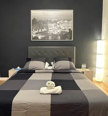 Un ou plusieurs lits dans un hébergement de l'établissement Family Champs Elysées appartement