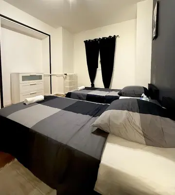 Un ou plusieurs lits dans un hébergement de l'établissement Family Champs Elysées appartement