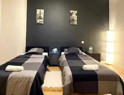 Un ou plusieurs lits dans un hébergement de l'établissement Family Champs Elysées appartement