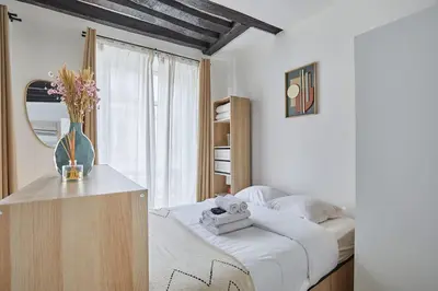 Un ou plusieurs lits dans un hébergement de l'établissement Charming Studio Center of Paris