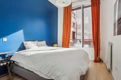 Un ou plusieurs lits dans un hébergement de l'établissement Appartement Le Rostand