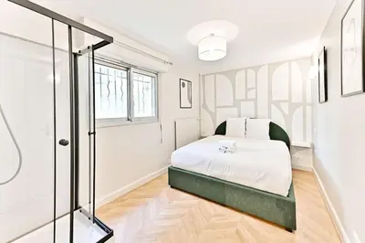 Un ou plusieurs lits dans un hébergement de l'établissement Appartement spacieux et paisible Paris 19ème - II