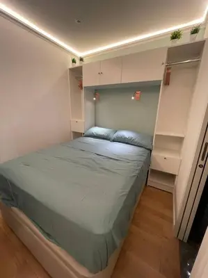Un ou plusieurs lits dans un hébergement de l'établissement Cosy Appart Paris 8e champs elysees Miromesnil