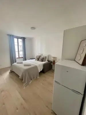 Un ou plusieurs lits dans un hébergement de l'établissement Boutiques Apartments Paris