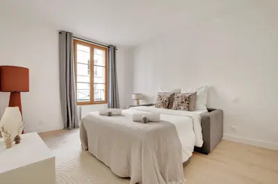 Un ou plusieurs lits dans un hébergement de l'établissement Boutiques Apartments Paris