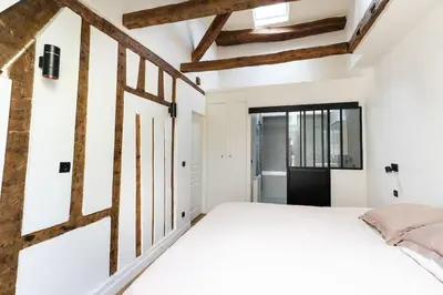 Un ou plusieurs lits dans un hébergement de l'établissement Appartement Place des Vosges, Marais Bastille