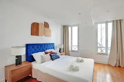 Un ou plusieurs lits dans un hébergement de l'établissement Boutique Appartements Madeleine