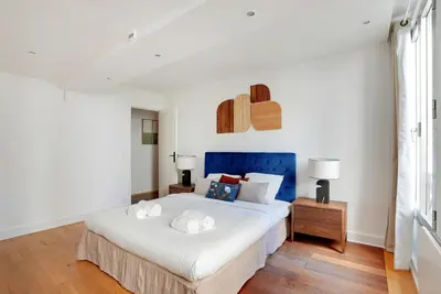 Un ou plusieurs lits dans un hébergement de l'établissement Boutique Appartements Madeleine