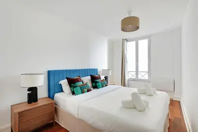 Un ou plusieurs lits dans un hébergement de l'établissement Boutique Appartements Madeleine