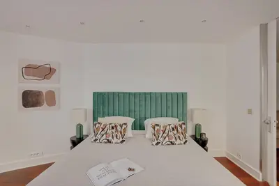 Un ou plusieurs lits dans un hébergement de l'établissement Boutique Appartements Madeleine