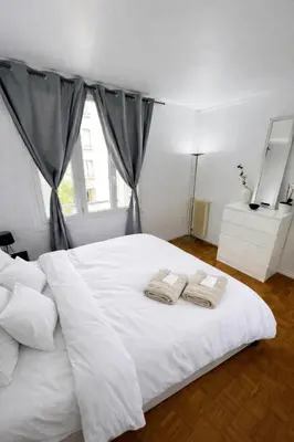 Un ou plusieurs lits dans un hébergement de l'établissement Magnifique appartement Paris 11ème