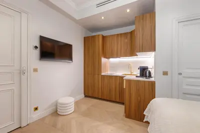 Un ou plusieurs lits dans un hébergement de l'établissement Charming Pied-à-Terre Champs-Élysée